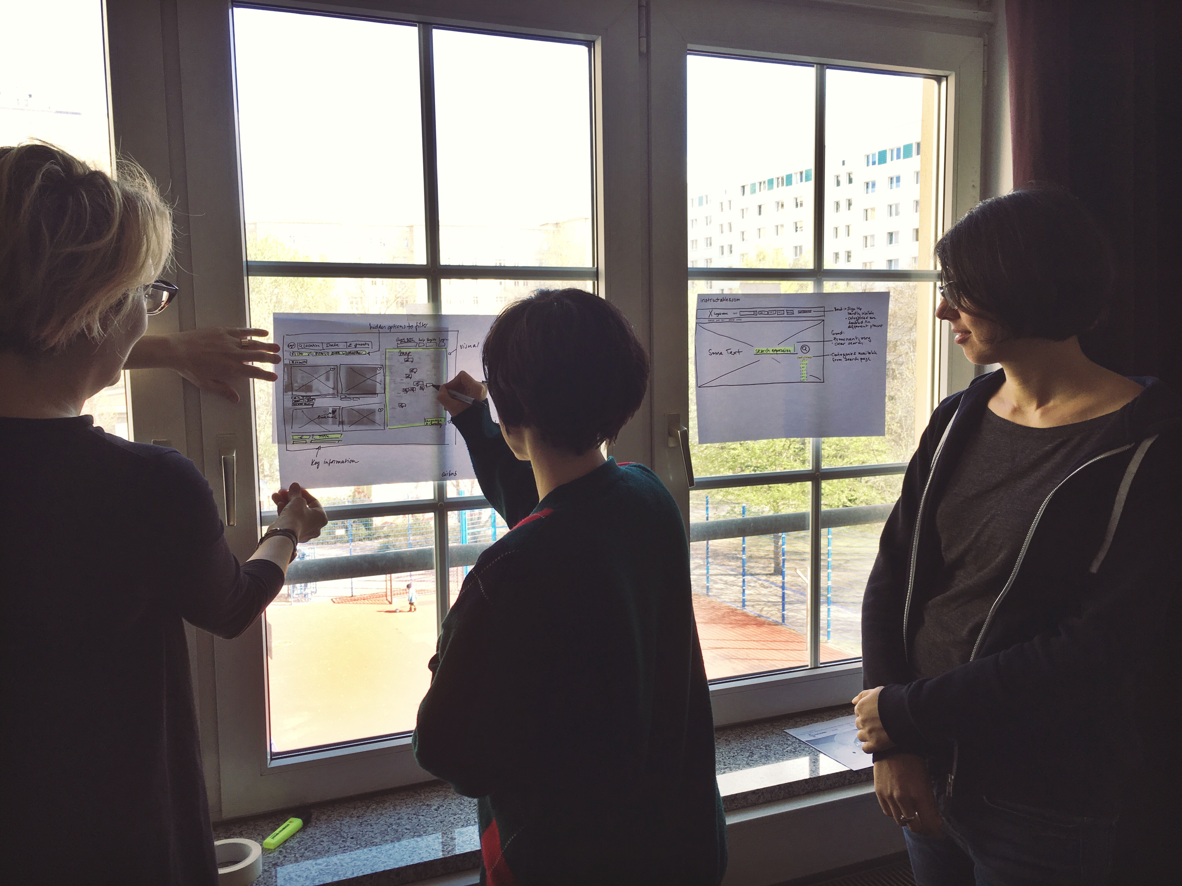 Developers sketching wireframes on paper.
